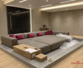 серый диван с крашными подушками в кинотеатр